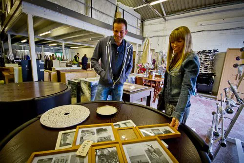 Customers looking over a dining table on the shop floor at Doncaster Refurnish