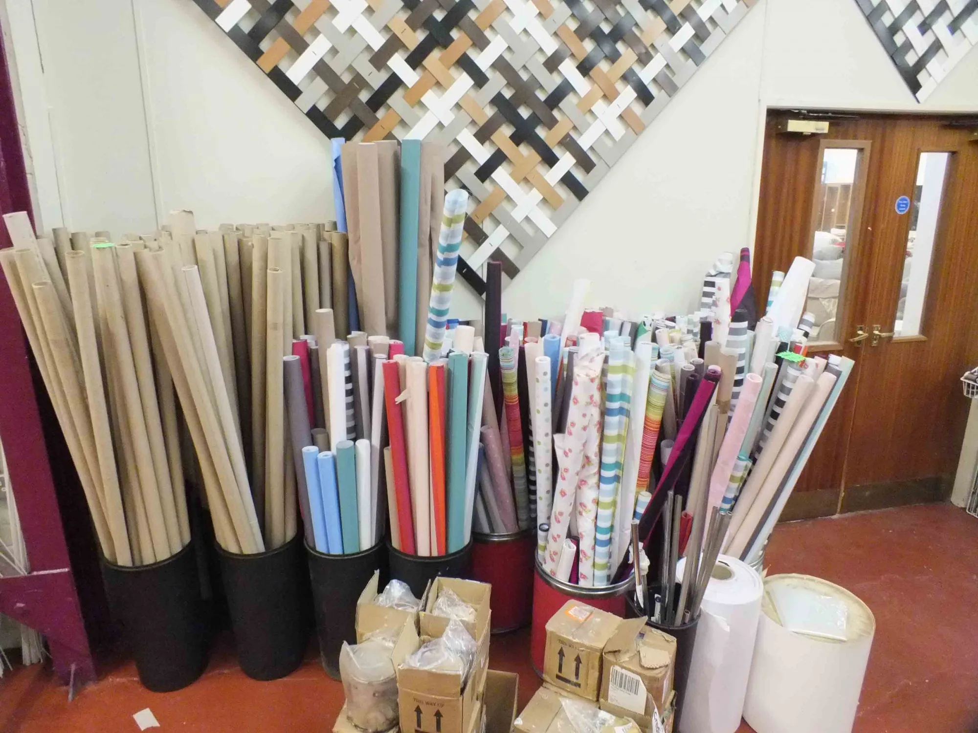 Rolls of upholstery fabric stood on display in a Doncaster Refurnish shop