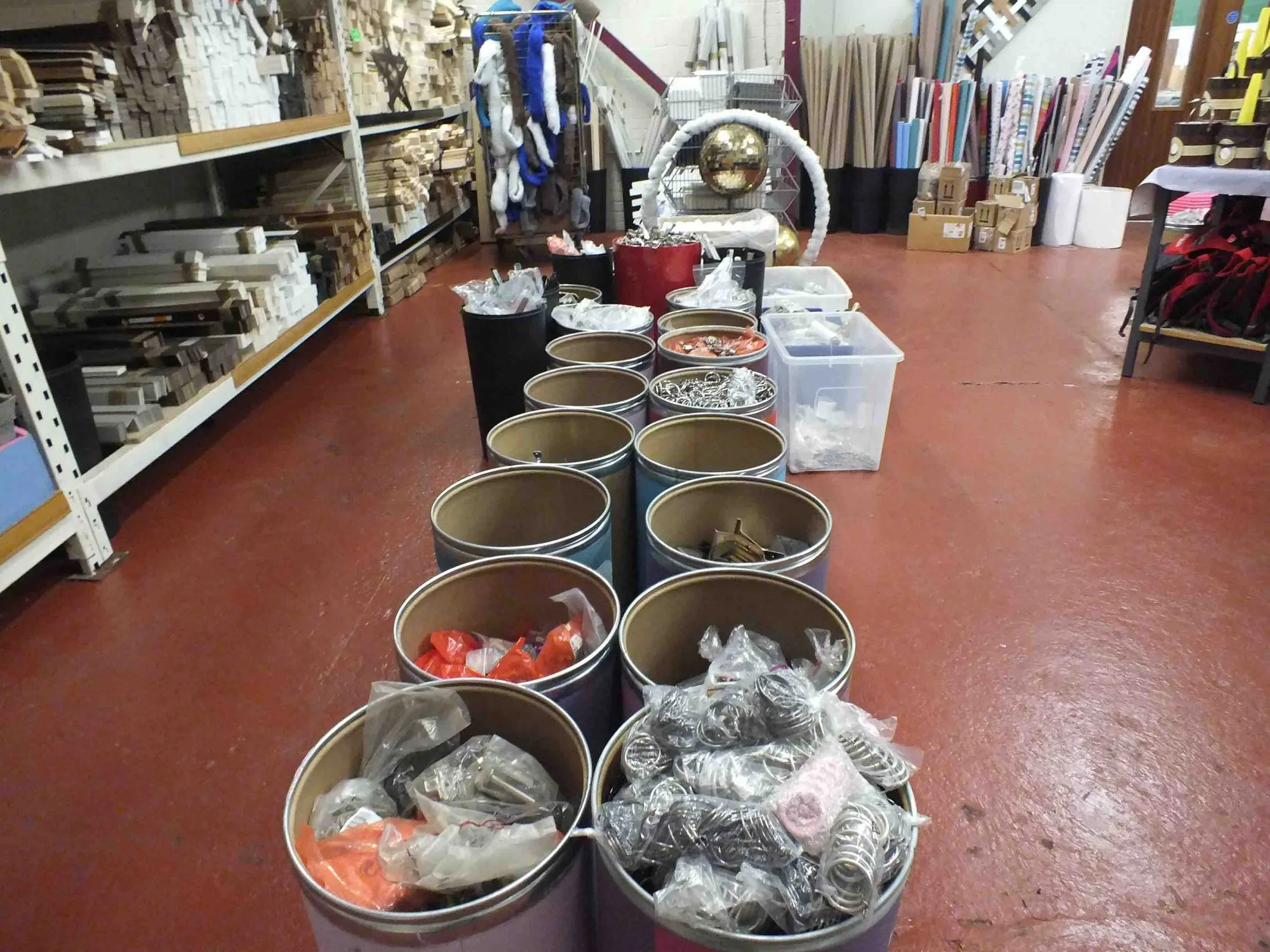Tins of furniture paint and hardware set out on a shop display in Doncaster Refurnish