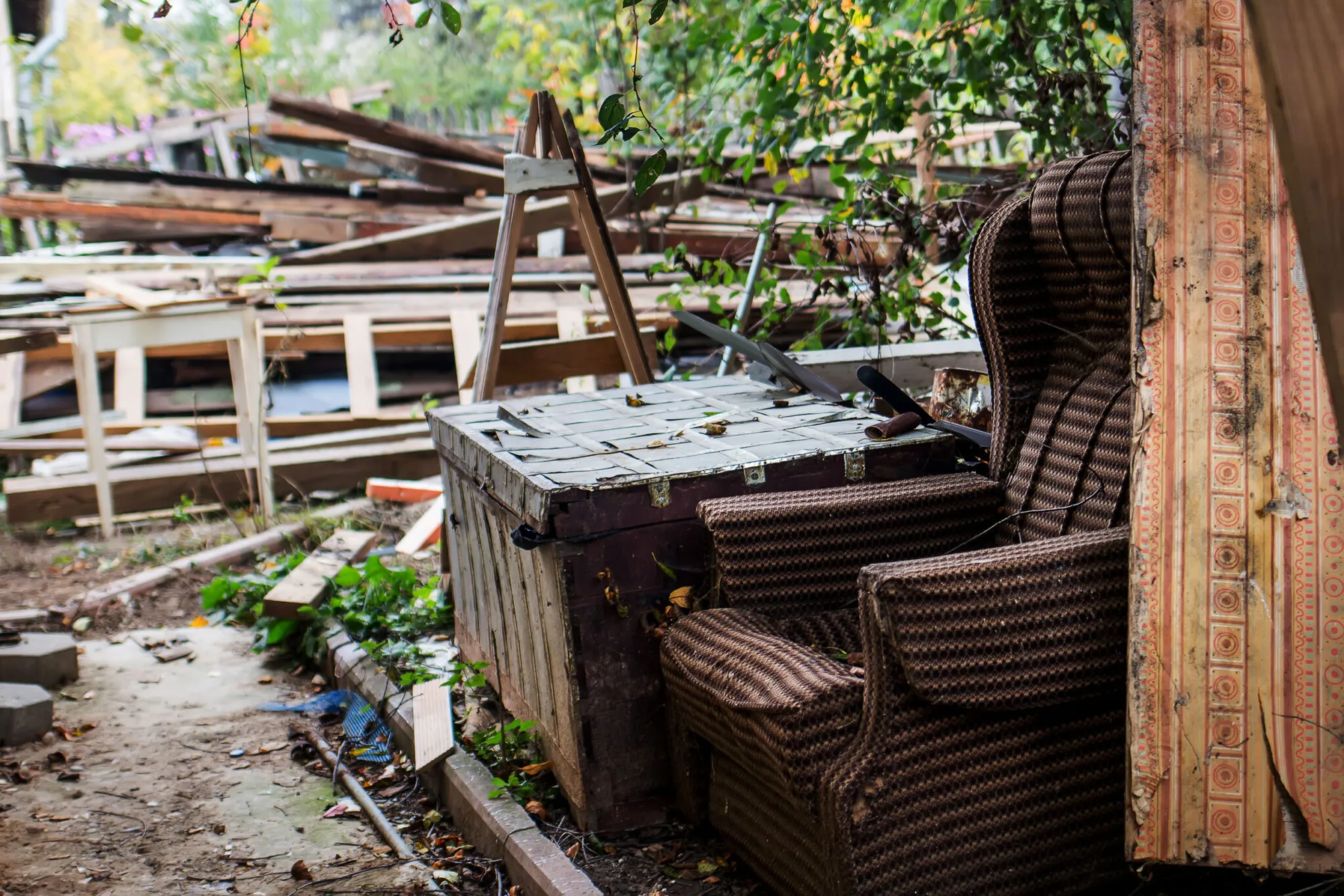 Reclaimed furniture and timber stacked in the yard, waiting to be sorted