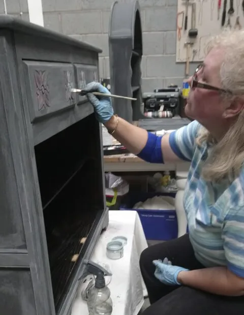 A cabinet being repainted and restored in the workshop