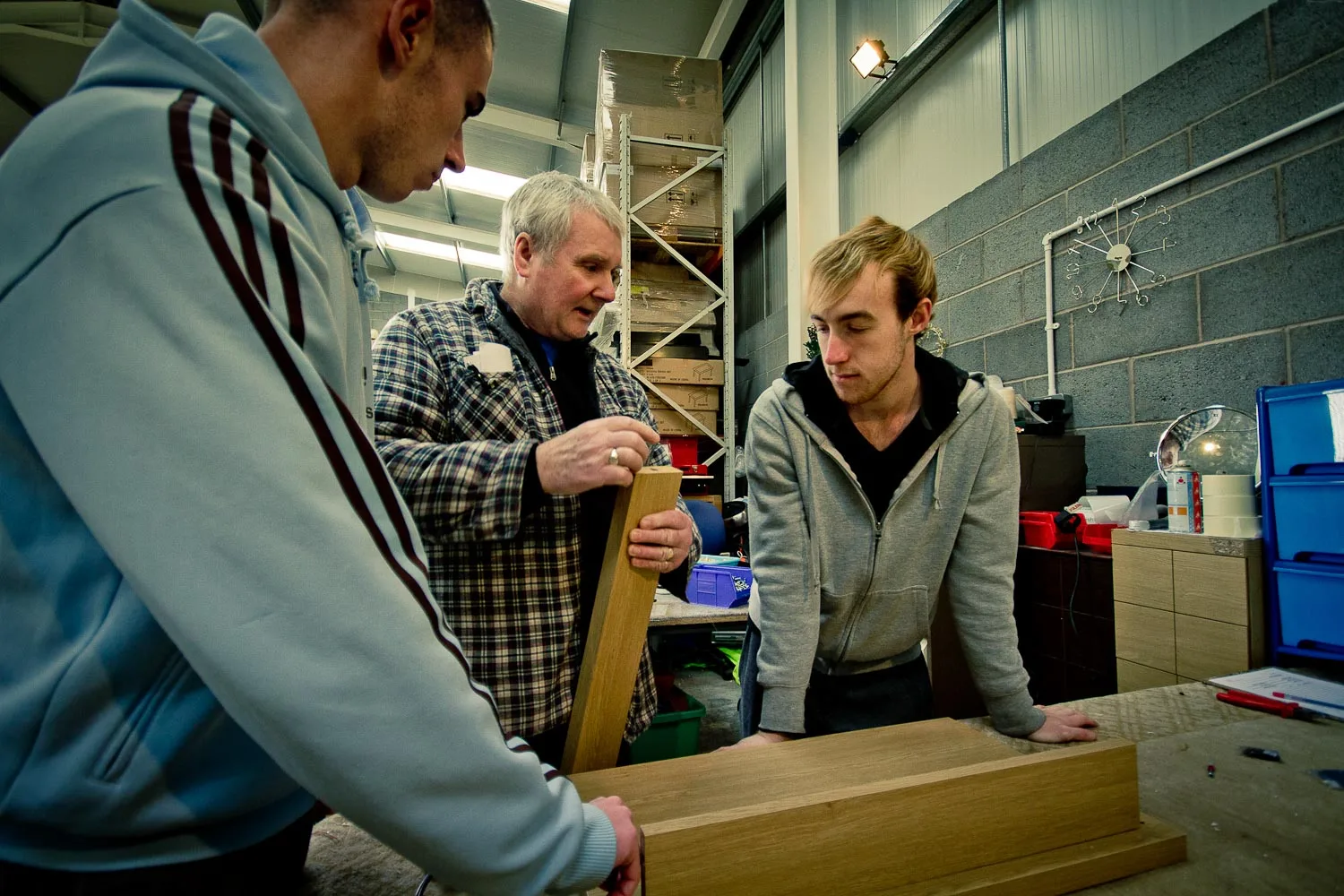 A member of the Doncaster Refurnish team assessing a piece of donated furniture
