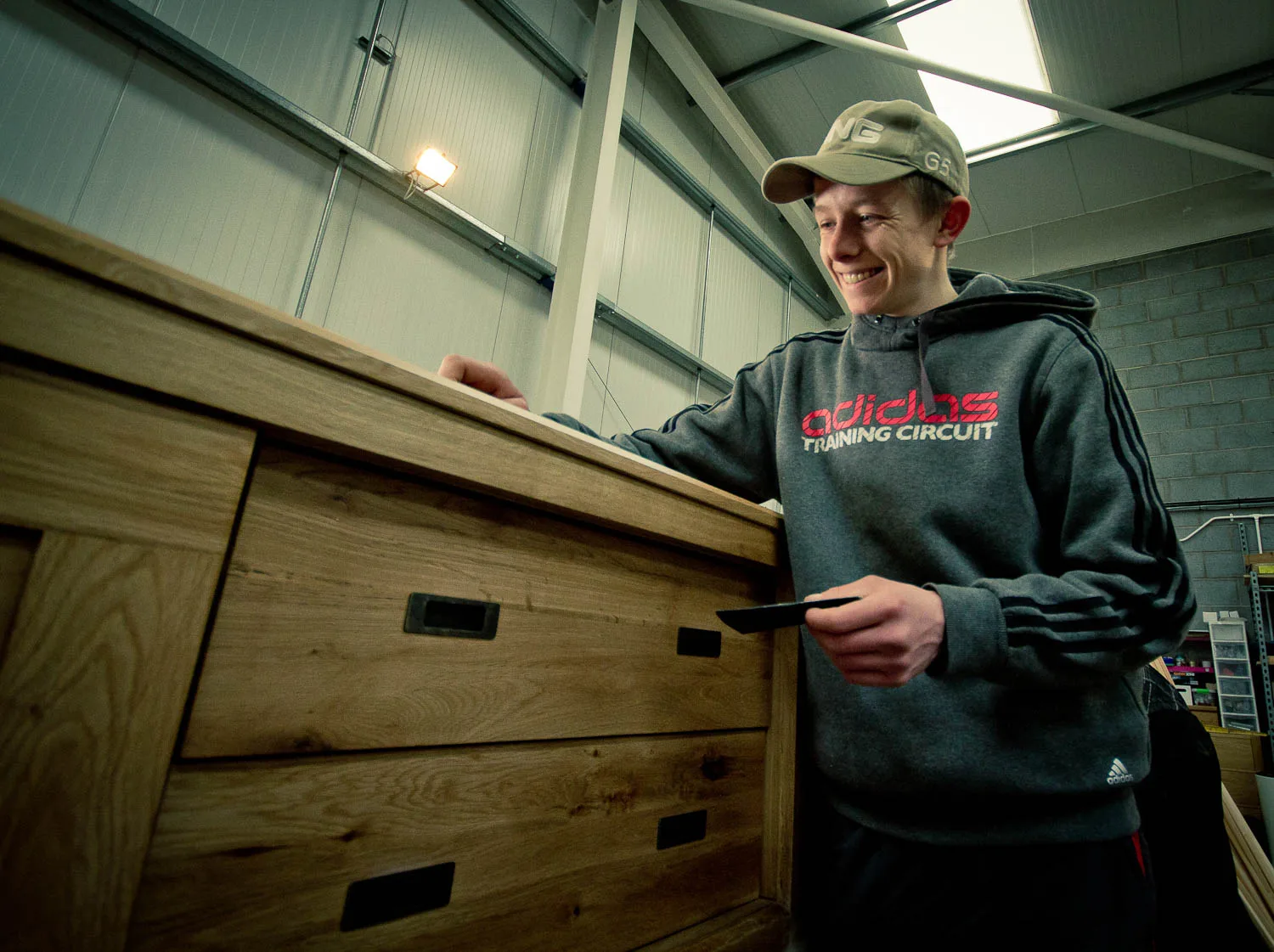 A member of the team moving a restored chest of drawers